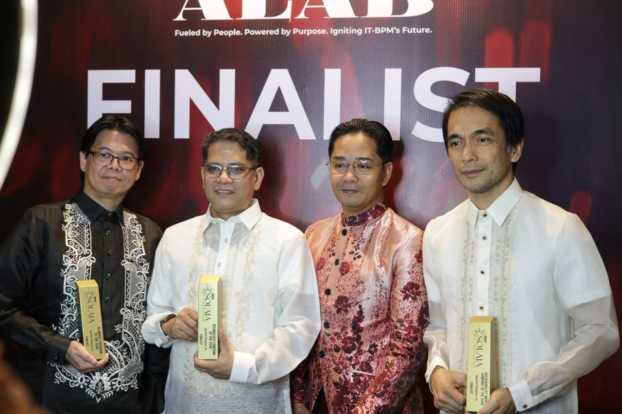 OpenText Philippines leaders holding SOLAIA finalist trophies at the awards night